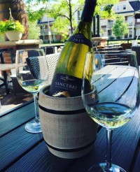 bottle of wine being chilled at symposium bar ontario restaurants patio