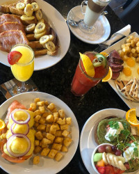 best aurora restaurant brunch, breakfast cocktails and table of various breakfast options at symposium cafe near me