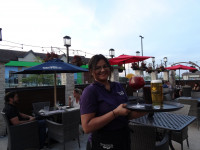 wait staff serving bar drinks on the patio at symposium restaurants